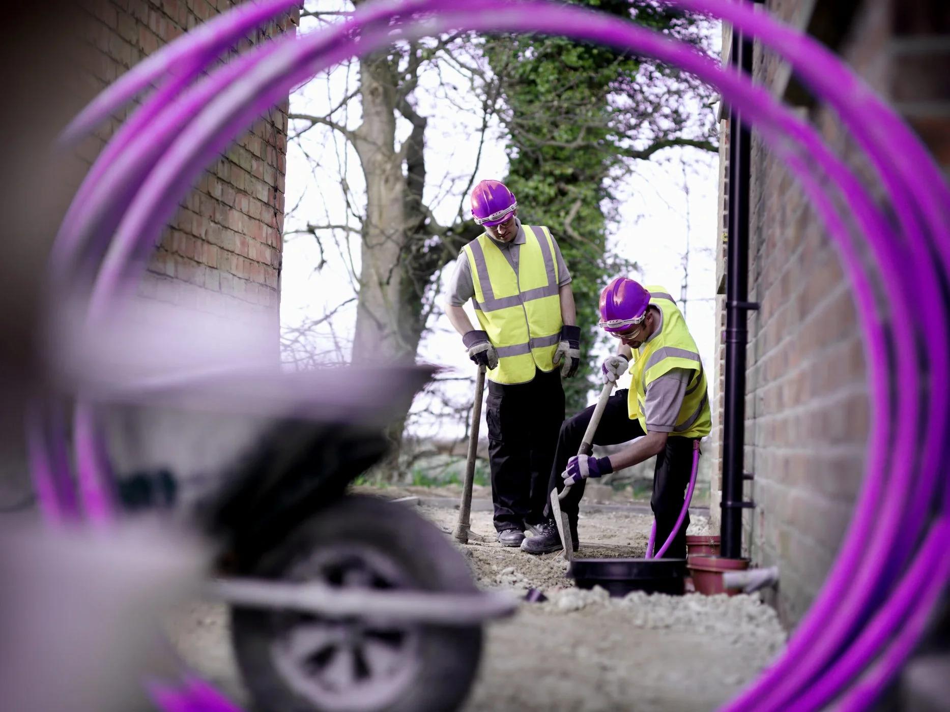 guys-working-purple-fiber-cable-scaled jpeg